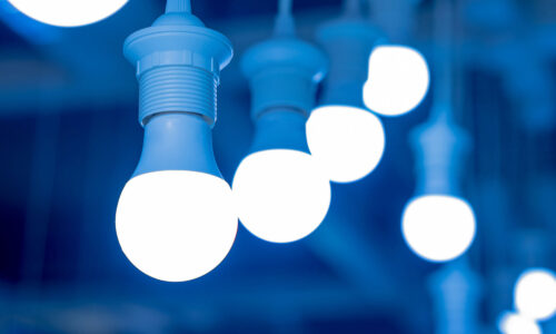Bright white LED light bulbs against a blue backdrop.