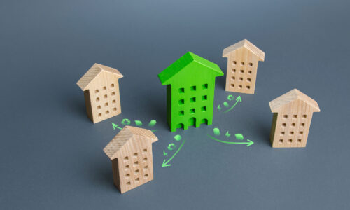 A dark background with wooden houses spaces out, one is bright green with illustrative arrows pointing towards the houses