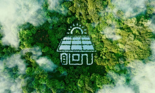 A birds eye view of a forest with green trees and then a illustration of a house/building with solar panels on it.